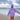 Pink tie-dye hoodie featuring an inspirational self-love quote, worn by a smiling person enjoying a beach setting with a cloudy sky in the background.