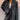 Pinstripe double-breasted blazer in grey, featuring classic business and formal wear design with a structured collar, long sleeves, and tailored fit extending to the waist and thighs, styled with a dress shirt underneath.