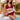 Plus size black crochet halter bikini set featuring a high-waisted design, worn by a model accessorized with a fedora and sunglasses.