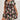 Plus size blue floral tropical print knee-length summer dress with short sleeves, worn by a model with dark hair, standing outdoors with greenery in the background.