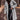 Plush beige faux fur winter coat modeled by a woman with shoulder-length hair, wearing sunglasses and stylish outerwear in a gray color, size XL.