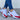 Breathable mesh slip-on sneakers in red and blue with a lightweight design, displayed in size 43, shown on a person wearing white pants.