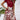 A model wearing a high-waisted red floral A-line skirt paired with a white top featuring green accents, highlighting the stylish and feminine design of the women's fashion outfit.