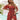 Woman wearing a red floral off-shoulder boho mini dress featuring a skater style, showcasing shoulder and thigh areas.