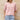 A red linen blouse for women with a v-neck and short sleeves, designed for summer wear, displayed in a pink color in XL size.