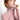 Light pink ribbed turtleneck sweater worn by a person with elegant gold pearl hoop earrings, showcasing a chic winter fashion look.