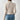 Ribbed high-neck cutout sweater in grey, featuring a chic turtleneck design with long sleeves, styled with denim jeans.