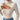 A white ribbed high-neck cutout sweater featuring a chic turtleneck design, with long sleeves and stylish cutout detailing on the shoulder area.