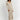 Ribbed V-neck cream maxi sweater dress with long sleeves, worn by a person standing, showcasing fall fashion style.