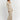 A ribbed cream maxi sweater dress featuring a V-neckline and long sleeves, showcasing fall fashion with its elegant design.