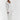 Ribbed V-neck cream maxi sweater dress with long sleeves, showcasing a fall fashion look with a focus on the neckline, waist, and sleeve details.