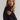 Cream-colored ribbed V-neck maxi sweater dress with long sleeves, perfect for fall fashion, worn by a person with shoulder-length hair.