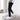 Men's black tapered track pants on a hanger, showcasing slim fit design with moisture-wicking fabric, emphasizing the waist, thigh, and knee areas.