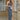 Royal blue V-neck backless bodycon evening gown worn by a person standing, highlighting the form-fitting design with emphasis on the shoulders, waist, and thighs.
