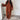 A rust-colored wide-sleeve sweater and pants knit set, featuring a cozy loungewear design in dark brown, displayed in an XL size with a focus on the neck, sleeve, and waist areas. The background includes wooden flooring.