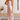 Elegant rust satin midi slip dress with a backless design and tie-back detail, featuring a sleek one-piece garment draped elegantly over the shoulders and arms.