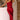 Rust satin midi slip dress featuring a backless design with a tie-back detail, shown on a model. The dress elegantly drapes over the body, highlighting the shoulders and waist, with a smooth, flowing fabric that extends to a midi length.
