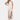 A woman wearing a sage green sleeveless maxi dress that is styled as a casual beach sundress. The dress features a flowing design, perfect for a relaxed day out. She is smiling and standing in a relaxed pose, with attention to the dress's waistline and flowing length.