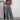 Shimmery silver strapless metallic jumpsuit designed for evening party wear, featuring a one-piece style with a fitted waist and sleek neckline, in a grey color.
