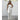 Strapless silver metallic jumpsuit with a shimmery finish, perfect for evening parties, shown on a model in a standing pose. The outfit is sleeveless, highlighting the arms and shoulders, with a fitted silhouette accentuating the legs. The model is smiling, complementing the elegant look of the jumpsuit.
