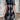 A stylish short summer dress featuring an asymmetric geometric pattern, designed as streetwear with a one-piece garment style. The dress highlights shoulder and neck details, includes short sleeves, and is fitted at the waist, perfectly suited for daytime outings.