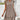 Short summer dress with geometric print, featuring a keyhole neckline and tassels, shown in XXL(46) size. The dress is white with short sleeves and a knee-length hem.