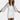 Sparkly silver sequin puff sleeve mini dress suitable for cocktail parties, elegantly showcasing a sheath silhouette with a flattering fit. The dress features short puff sleeves and a sleek one-piece design, worn by a model showcasing her hairstyle and a confident posture with arms slightly bent.