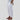 Silver wide-band cuff bracelet with a layered and textured design displayed on a model wearing a white dress.
