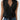 Sleeveless black wrap blouse with a V-neck design, featuring an elegant and stylish look suitable for business or formal occasions.