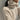 A lightweight winter sweater made from soft cashmere in a luxury beige color, featuring a crewneck design and long sleeves. The garment is styled with a subtle woolen texture and may be layered over other clothing for added warmth.