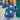 Blue and white star pattern crewneck sweater worn by a smiling person, showcasing the knitwear's design on the shoulders and arms.