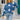 Blue and white star pattern crewneck sweater displayed on a mannequin, showcasing the casual knitwear design with long sleeves, suitable for pairing with jeans.