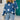 Blue and white crewneck sweater featuring a star pattern, with long sleeves and a casual knitwear design.