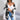 A woman wearing a striped black and white long sleeve cardigan with a relaxed fit, perfect for fall fashion. The cardigan features a stylish collar and is complemented by the woman's black hair.