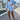 Striped blue blouse dress featuring a ruffled hem and drawstring waist, with long sleeves and a collared neckline.