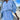 Striped blue blouse dress featuring a ruffled hem and drawstring waist, displayed on a model. The dress has a relaxed fit with a stylish shoulder design and a classic neckline, made from lightweight textile perfect for various occasions.