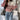 Striped black and white crewneck sweater for women, featuring a loose fit pullover design with long sleeves.
