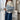 Striped black and white crewneck sweater for women with a loose fit, featuring long sleeves and a comfortable waist-length design.