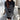 A woman wearing a black and white striped crewneck sweater with a loose fit design. The pullover features long sleeves and a relaxed collar, offering a casual and comfortable look. The sweater is styled to fit a variety of body shapes, as it is available in one size.
