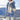 Striped fleece women's hooded sherpa jacket in warm colorblock plush featuring a mix of white, azure, blue, and grey hues with tartan pattern accents, shown on a standing model.