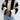 Striped knit sweater with bell sleeves for women, featuring a chunky knit design in white.