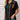A woman wearing a striped multicolor button-up blouse paired with jeans, smiling casually; showcasing a casual chic summer fashion style in XXL size.