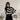 Oversized black and white striped knit sweater with a high collar and long sleeves, ideal for trendy autumn fashion.