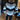 A woman wearing a striped sweater with long sleeves, paired with black leggings and white ankle boots, standing and posing in a chic autumn outfit.