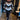 Woman wearing a striped sweater, black leggings, and white ankle boots standing with hands on hips, showcasing a chic autumn outfit.