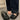 Stylish women's black platform orthopedic sandals with ankle strap, featuring a comfortable design. The image shows the sandals being worn with grey denim trousers, highlighting their fashionable appeal.