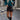 Teal cropped sweater paired with a faux leather mini skirt, showcasing fall fashion for women.