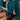 Teal cropped sweater paired with a black faux leather mini skirt, showcasing a stylish fall fashion look for women.