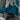 Teal cropped sweater paired with a black faux leather mini skirt, showcasing a stylish fall fashion outfit for women.