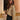 Woman wearing a textured gold metallic bomber jacket with a chic design, featuring ribbed cuffs and hem, a full-length zipper, and a high collar. The jacket is styled as part of a fashionable outfit, highlighting its unique texture and metallic sheen.